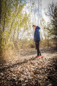 Full length of man standing in forest