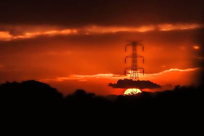 Low angle view of silhouette tower against sky during sunset