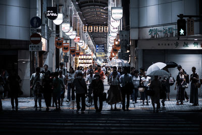 Group of people walking on city street
