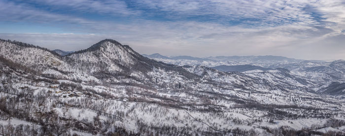 Scenic view of mountains against sky during winter