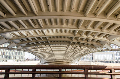 View under the deck of a modern bridge across the spree river with an advanced steel construction