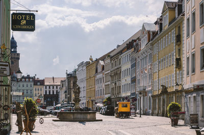 City street and buildings against sky