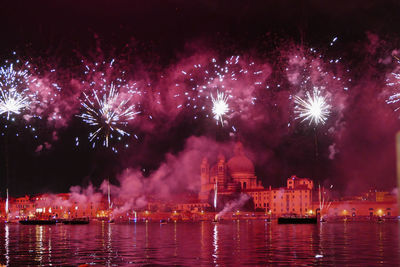 Low angle view of firework display at night