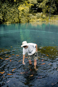 Full length of man standing by lake