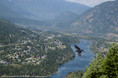 High angle view of river amidst mountains against sky