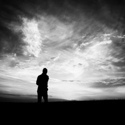 Silhouette of woman standing on field