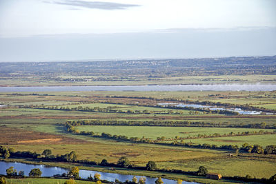 Scenic view of field against cloudy sky