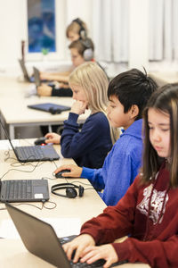 Children in classroom using laptops