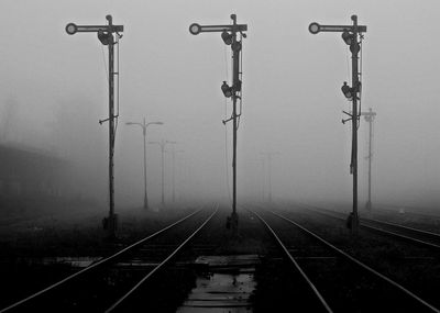 Railroad tracks against sky during foggy weather