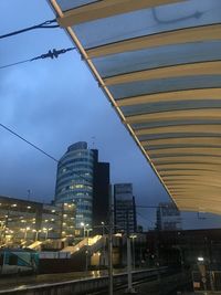Low angle view of illuminated buildings against sky at dusk