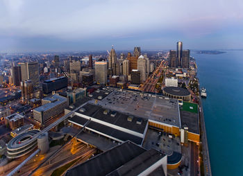 Aerial view of cityscape by sea against sky