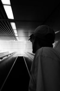 Low angle view of man standing on escalator