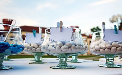 Close-up of wine glasses against sky