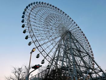 Low angle view of ferris wheel against clear sky