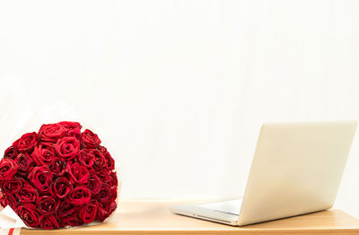 Close-up of red rose on table