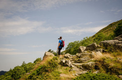 Man standing on mountain against sky