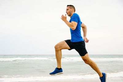 Full length of young man on beach