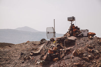 Satellite dish on mountain against clear sky during sunny day