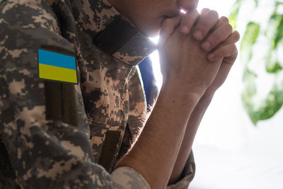 Ukrainian man warrior dressed in a military pixel uniform the yellow-blue flag of ukraine