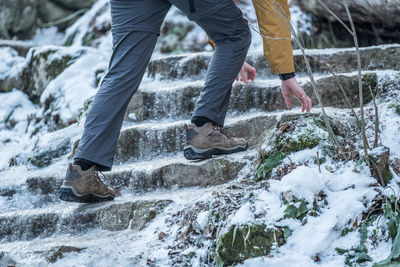 Man climbing up on slippery steps