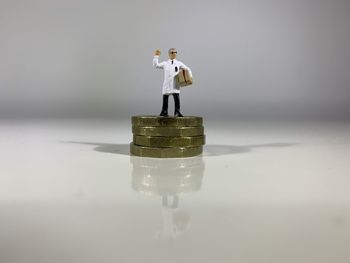 Close-up of figurine on table against white background