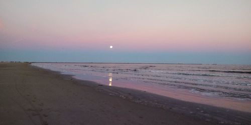 Scenic view of beach against sky during sunset