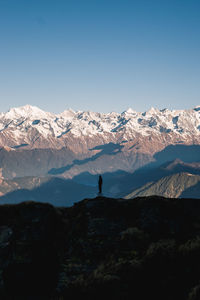 Scenic view of snowcapped mountains against blue sky