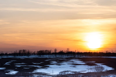 Scenic view of lake against romantic sky during sunset