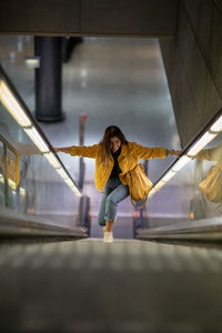 High angle view of young woman on escalator