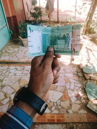 Cropped image of hand holding book