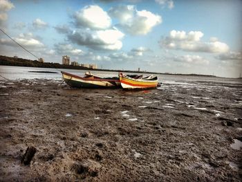 Boats moored on sea against sky