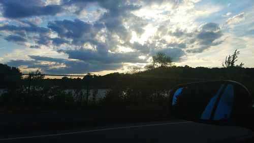 View of road against cloudy sky at sunset