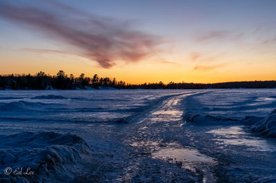 Scenic view of frozen sea against sky during sunset