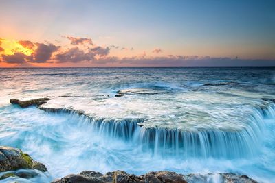 Scenic view of sea against sky during sunset