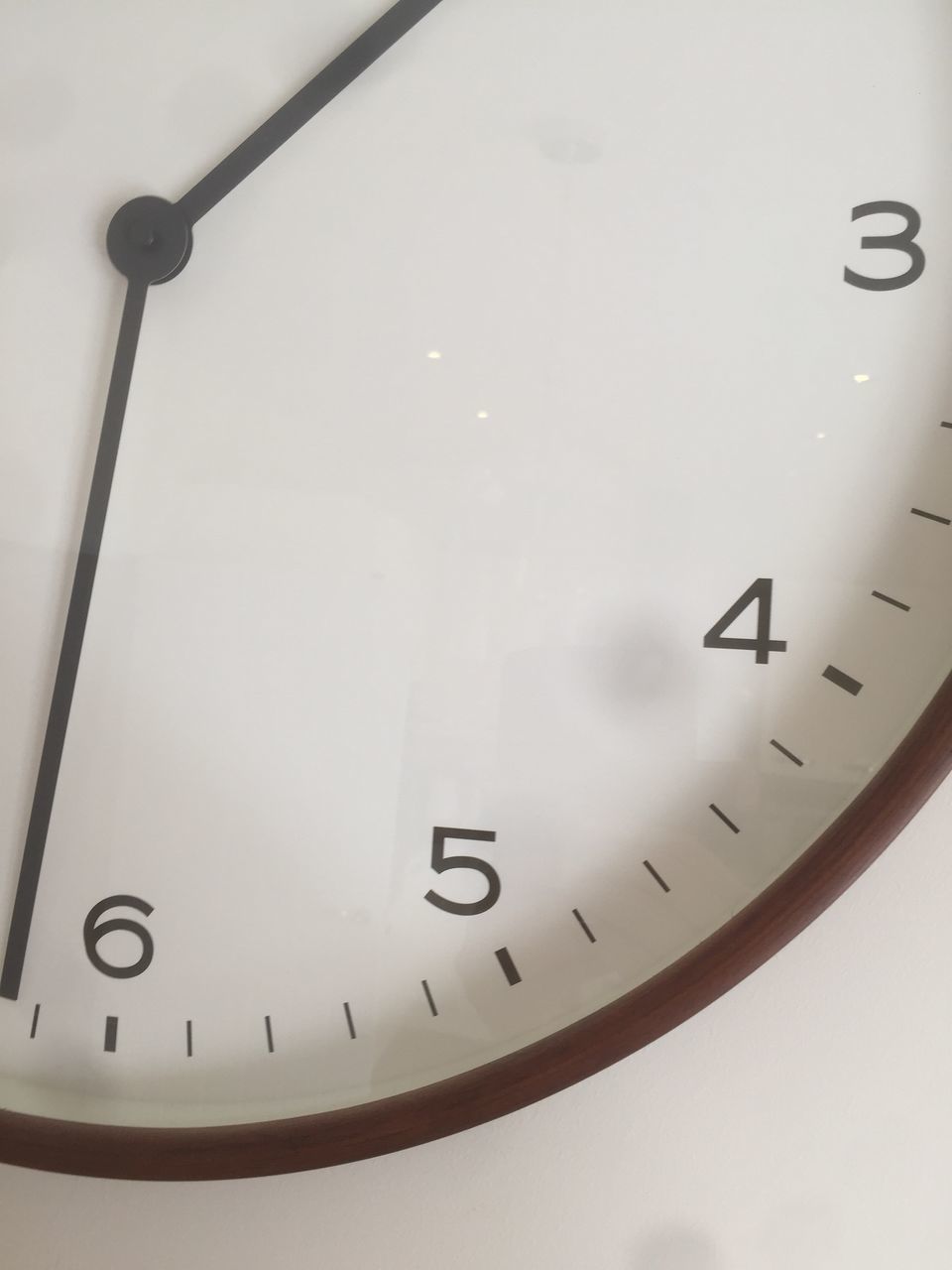 CLOSE-UP OF CLOCK ON WALL