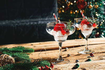 Christmas drink mimosa, punch or cranberry margarita cocktail serving in christmas ornaments