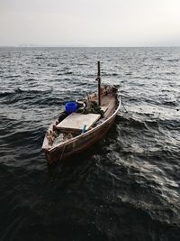 Boat moored on sea against sky