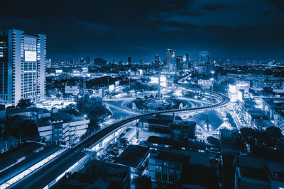 High angle view of illuminated buildings in city at night