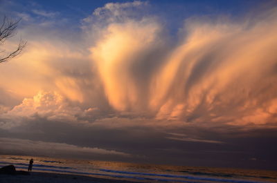 Scenic view of beach against sky during sunset