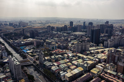 High angle view of modern buildings in city against sky