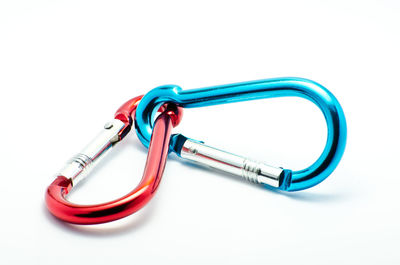 Close-up of metallic carabiners against white background