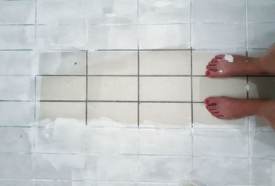 Low section of woman on tiled floor