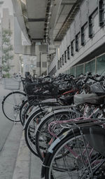 Bicycles parked in parking lot by building