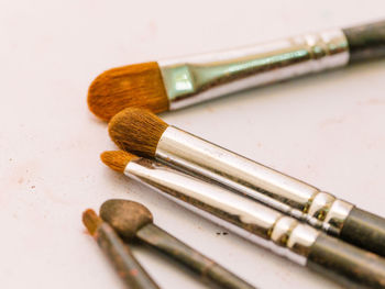 Close-up of make-up brushes on table