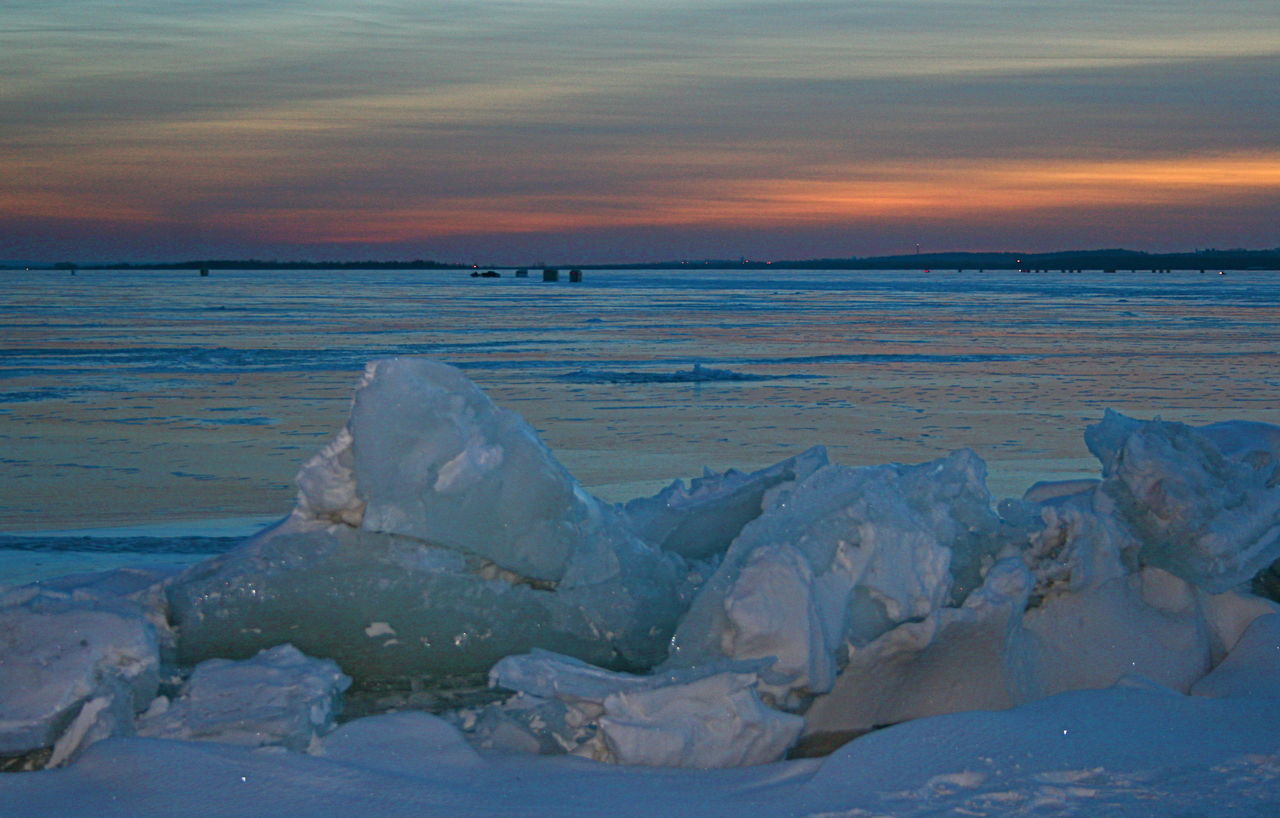 Ice fishing huts in background