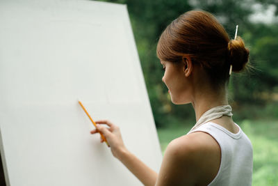 Side view of woman using digital tablet