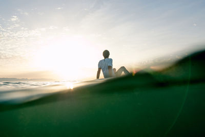 Concept: tranquility and relaxation. man sitting on paddle surf