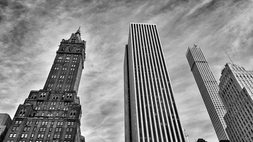 Low angle view of tower against cloudy sky