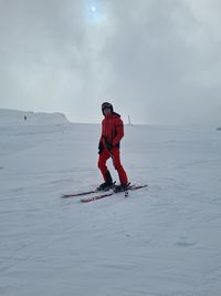 Full length of man skiing on snow against sky