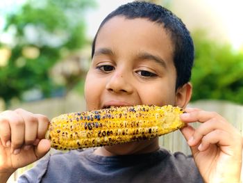 Close-up portrait of boy eating food